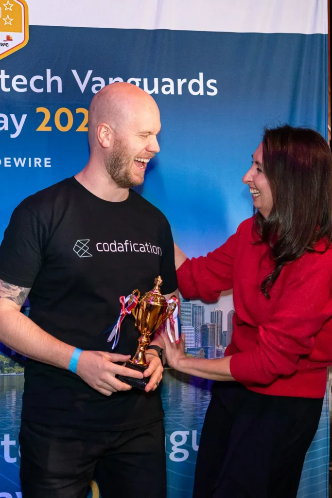 Pitch competition winner receiving trophy during Guidewire Insurtech Vanguards event