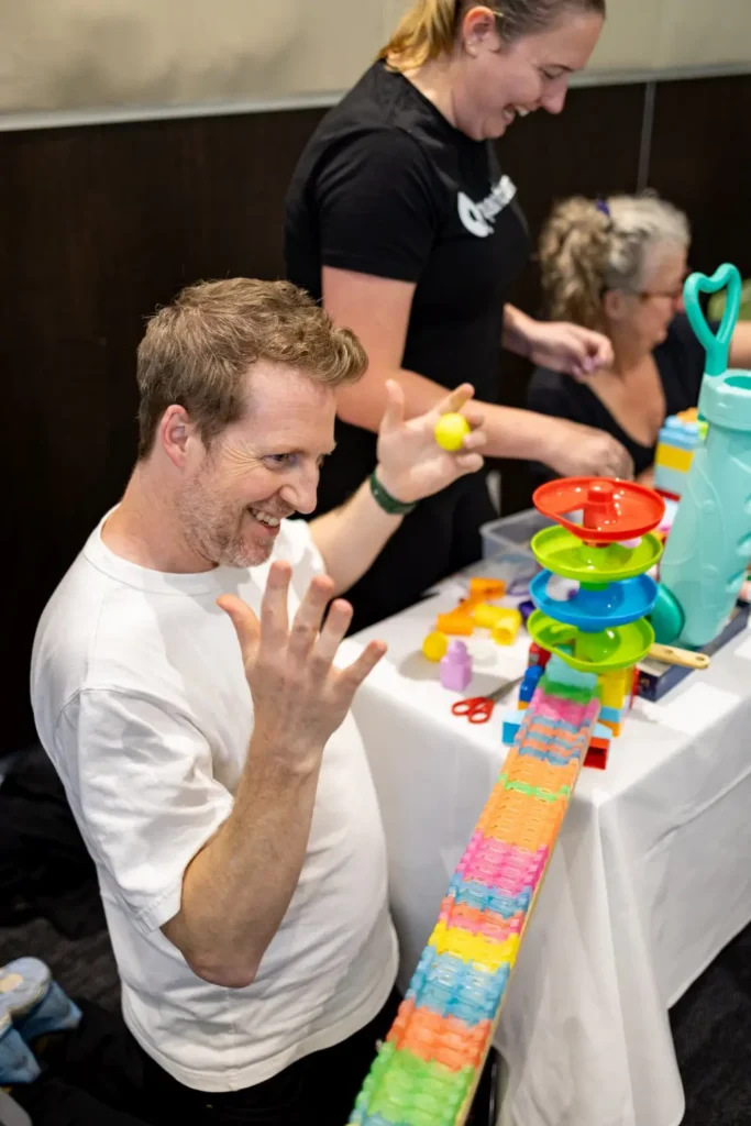 Team member enjoying a hands-on interactive corporate team building activity