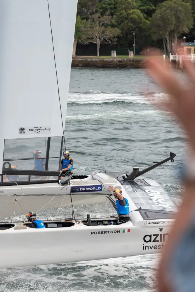 Italy SailGP crew waving while racing on Sydney Harbour during SailGP Sydney 2026