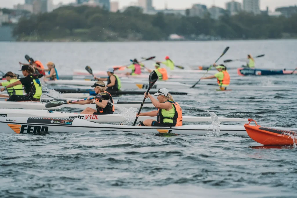 Kayakers racing through Sydney Harbour during the Bay to Beach event