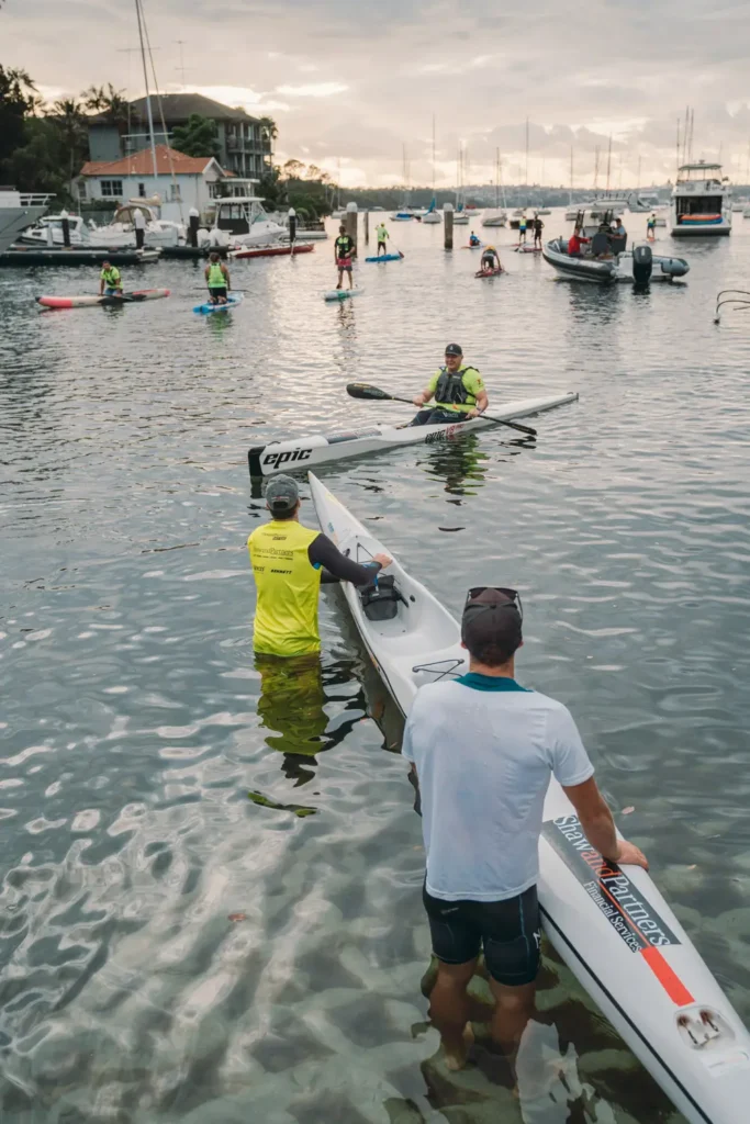 Athletes sharing a laugh before the start of the Sydney Harbour charity race