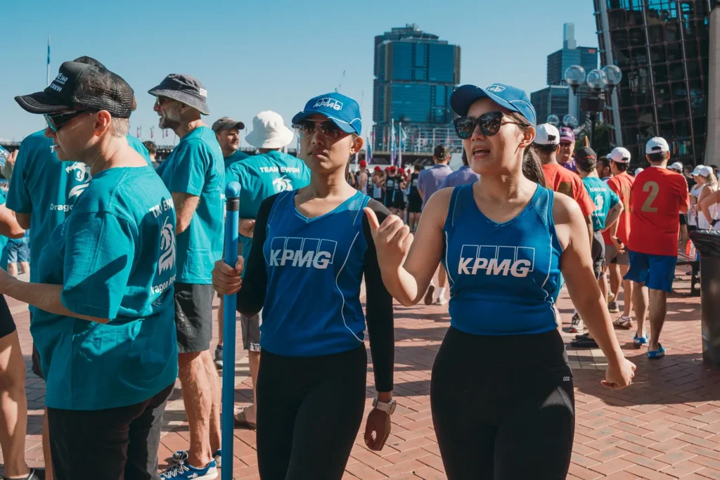 Participants from KPMG preparing for dragon boat races at Darling Harbour