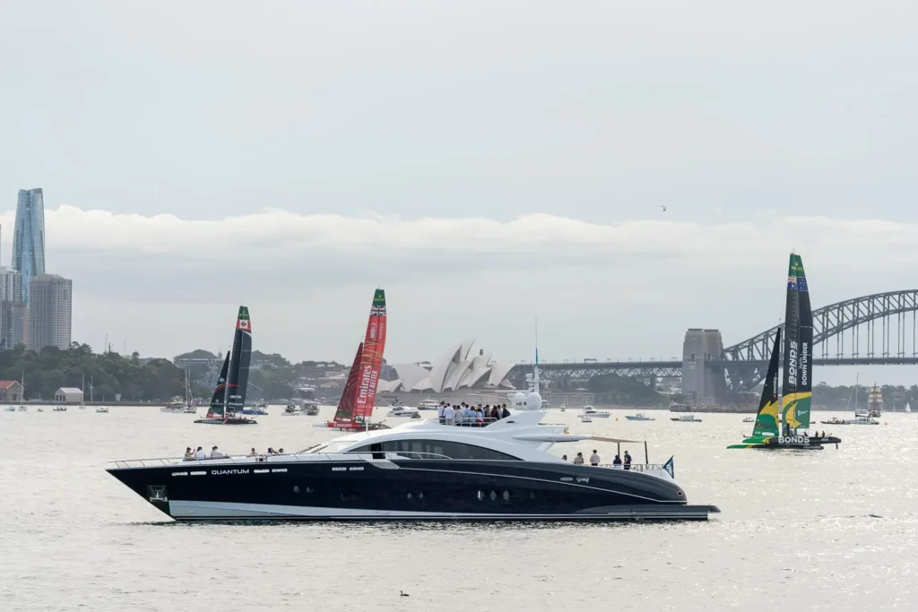Luxury yacht Quantum and SailGP race boats on Sydney Harbour during SailGP Sydney 2026