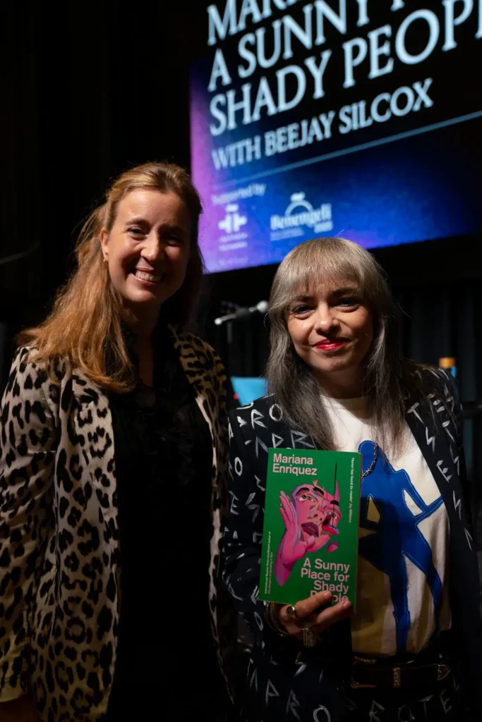Mariana Enriquez posing with Coral Martínez at Victoria State Library during Benegeli Festival
