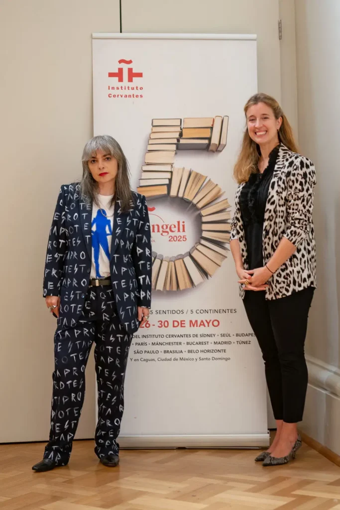 Mariana Enriquez photographed with Coral Martínez beside the Benengeli 2025 and Instituto Cervantes display in Melbourne