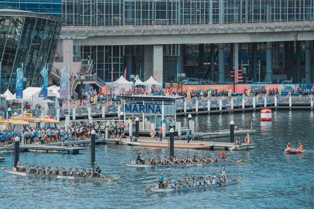 Elevated marina view of dragon boat races and crowds at Darling Harbour
