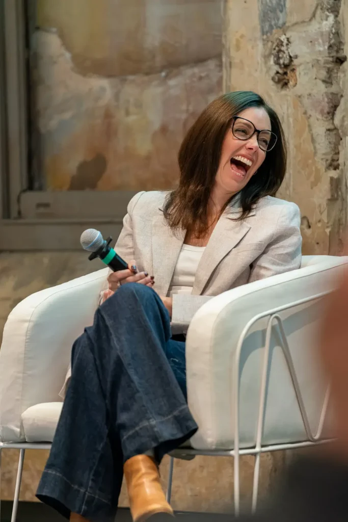 Megan Hughes smiles on stage of Hubspot Partner summit in Sydney