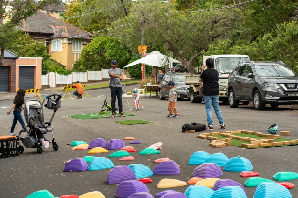Families enjoying outdoor games and activities on a traffic-free suburban street