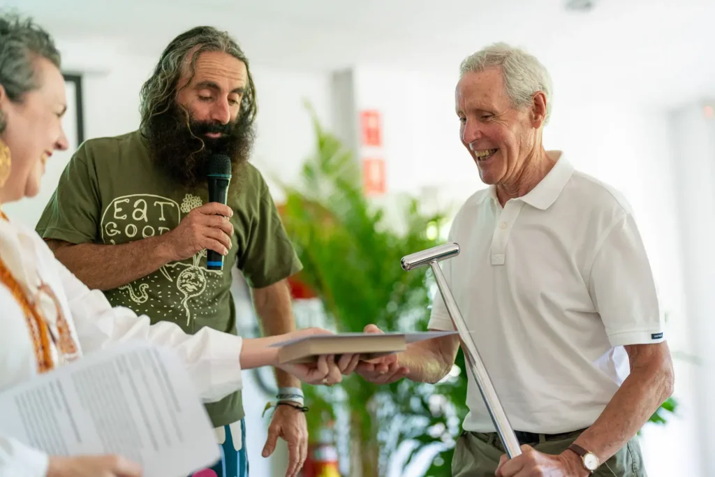 Man receiving award certificate during North Sydney garden competition presentation ceremony
