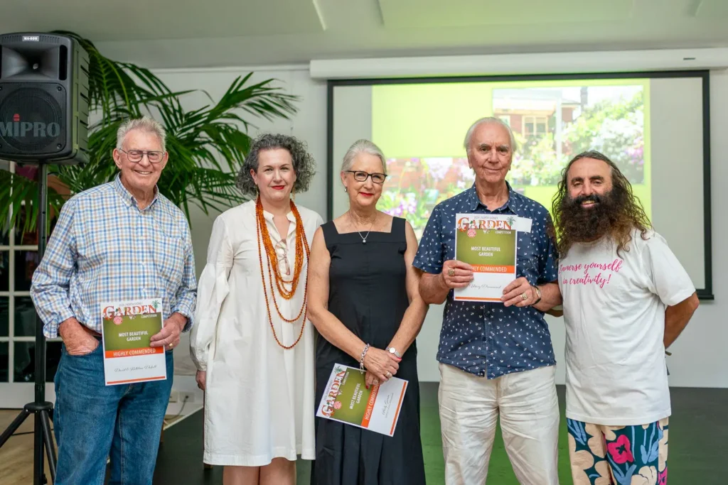 Winners and organisers posing with certificates at North Sydney garden competition awards