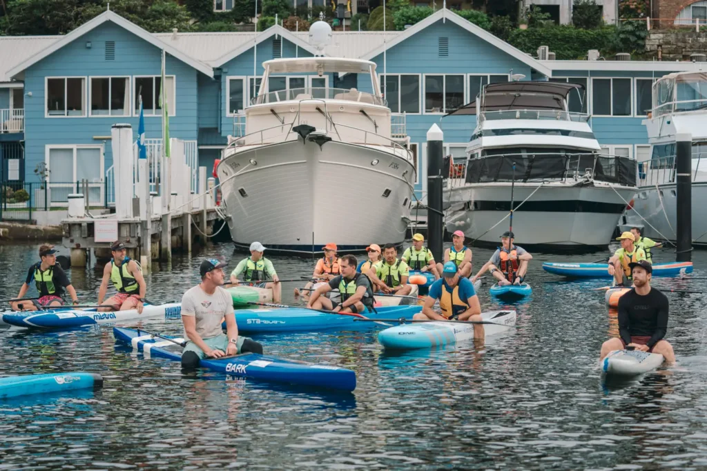 Paddleboard competitors preparing for the Sydney Harbour fundraising race