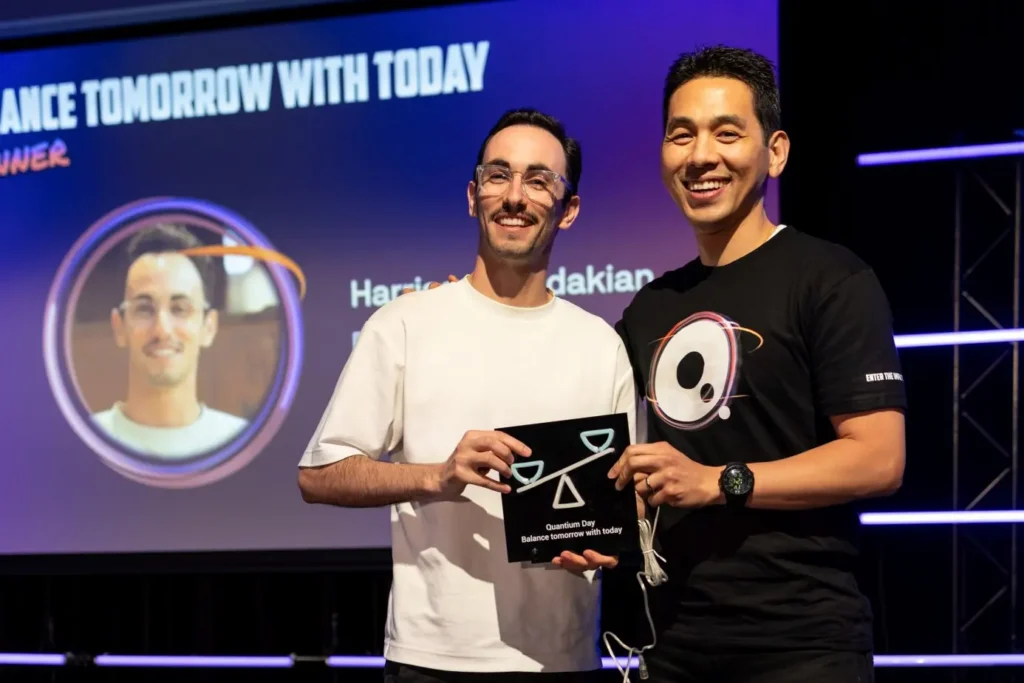 Quantum Day competition winner receiving illuminated award on stage