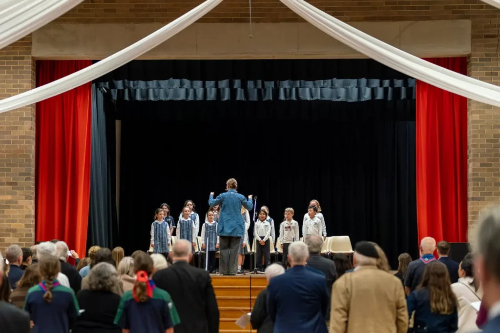 School choir performing on stage during Combined ANZAC Memorial Service