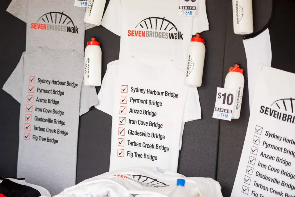 Seven Bridges Walk Sydney event merchandise including shirts and water bottles