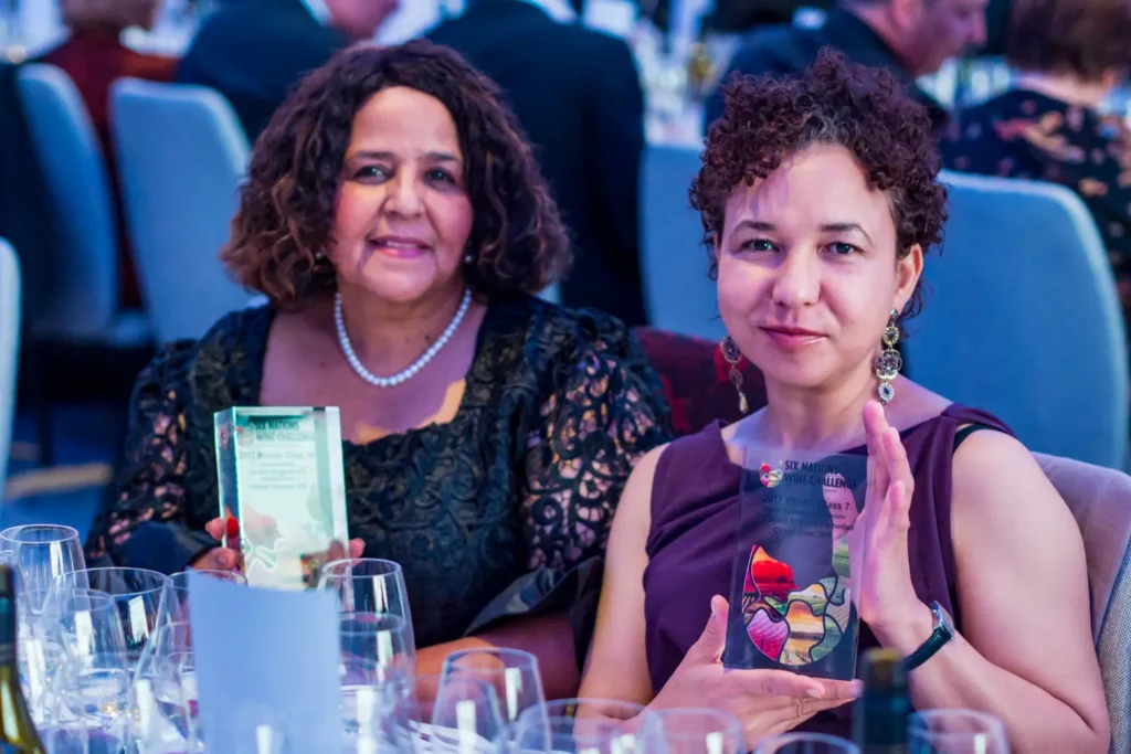 Wine challenge award winners holding trophies at gala dinner event