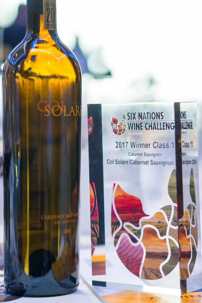 Award-winning Cabernet Sauvignon bottle displayed beside wine competition trophy