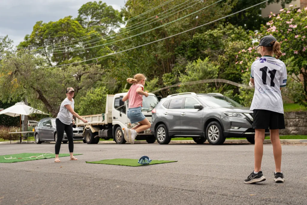 Families enjoying outdoor skipping games during community event in Sydney