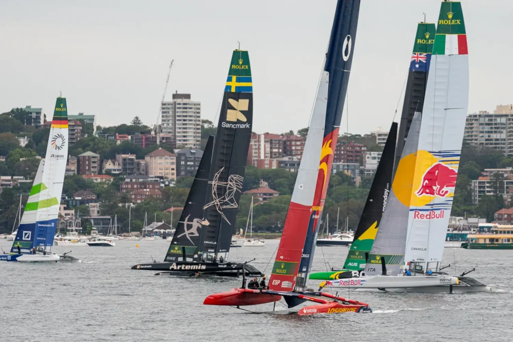 Spain SailGP catamaran foiling past Sweden, Australia and Red Bull Italy SailGP teams in Sydney Harbour