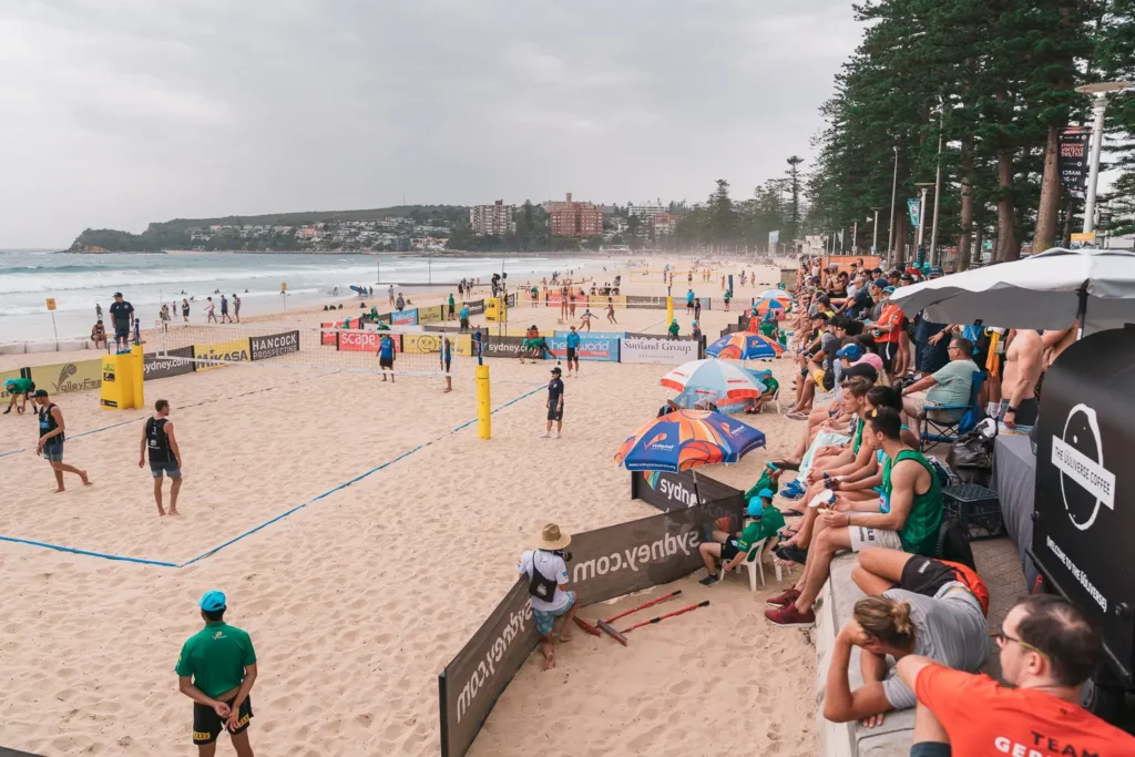 Spectators watching international beach volleyball courts along Manly Beach