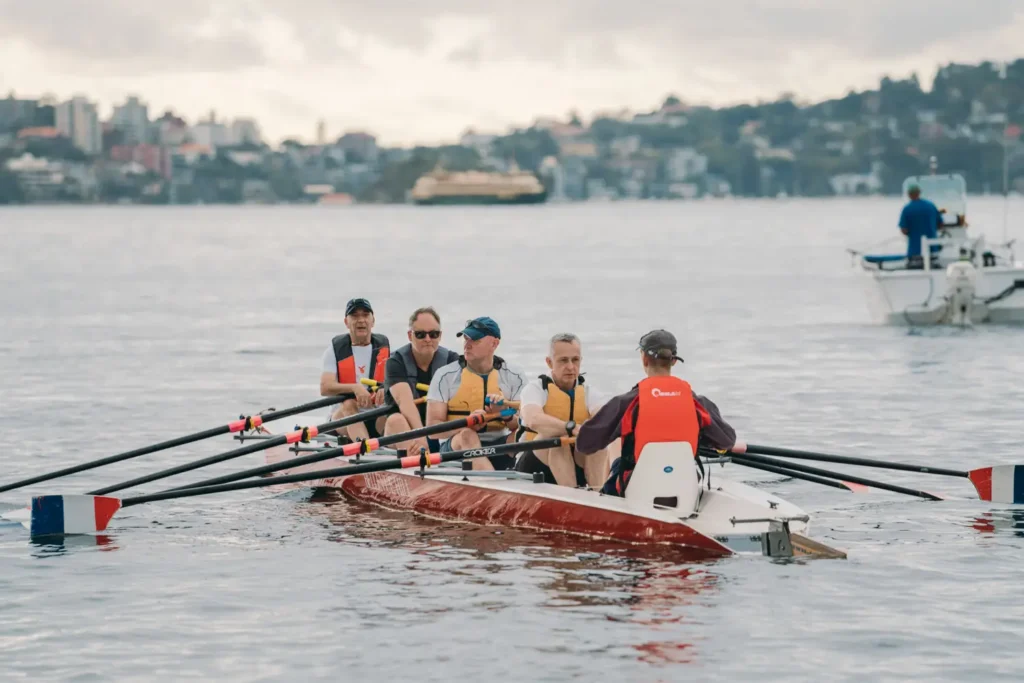 Competitors paddling across Sydney Harbour during the annual charity race
