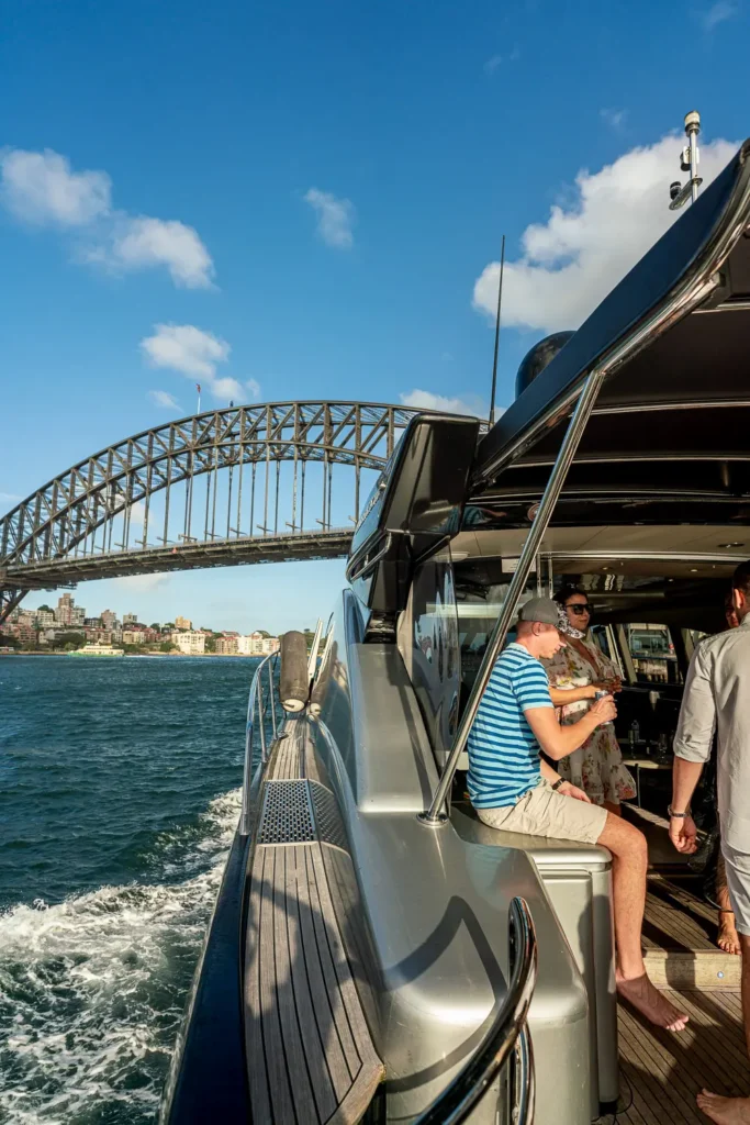 Corporate yacht event cruising beneath Sydney Harbour Bridge