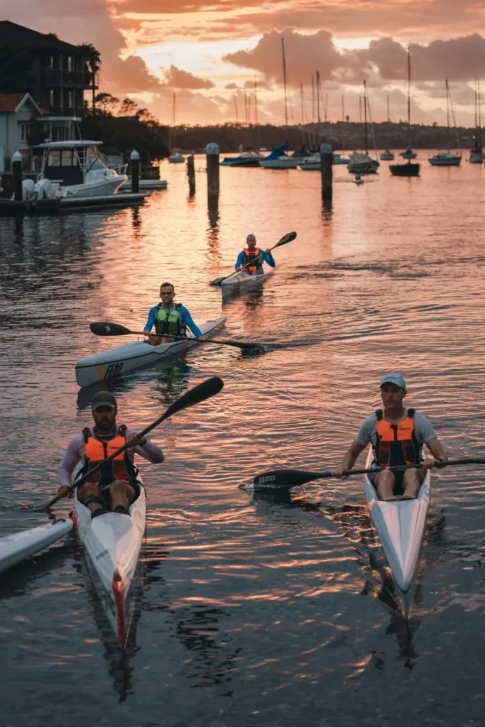 Paddlers arriving at sunrise on Sydney Harbour before the Bay to Beach fundraising race