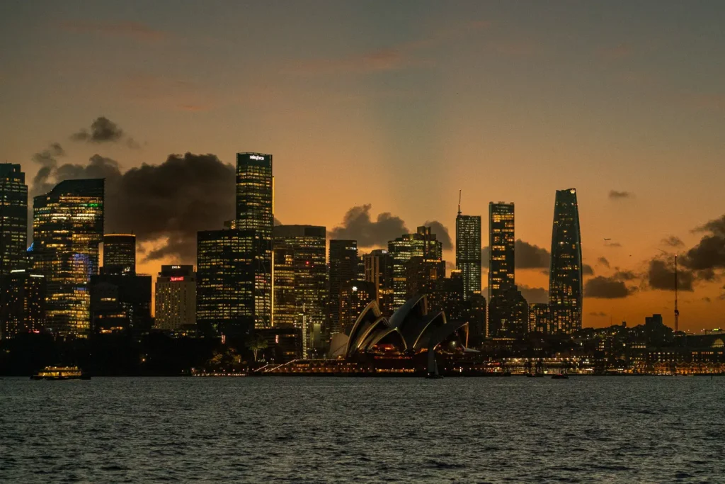 Night view of the Sydney Opera House and illuminated city skyline from the harbour