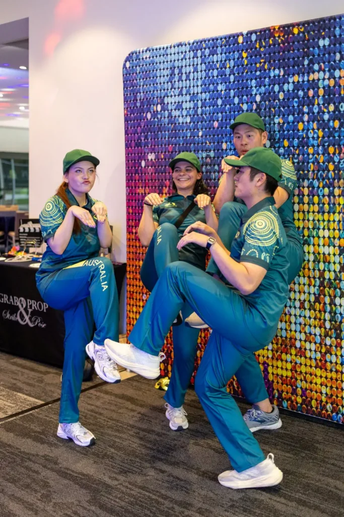 Team members in themed costumes posing during a corporate entertainment event