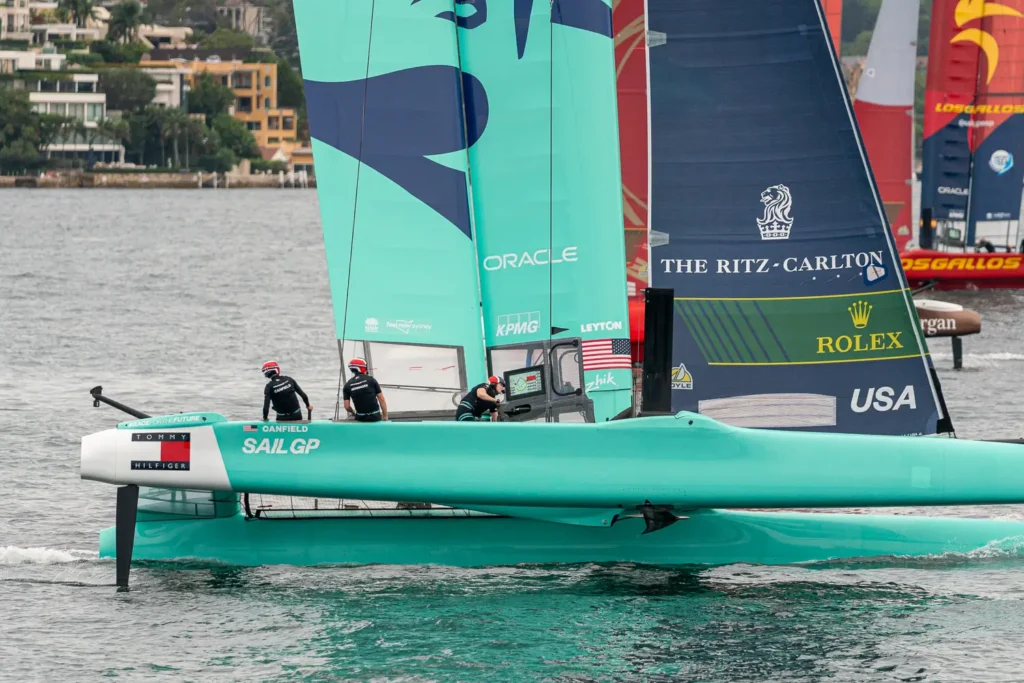 Close-up side view of the USA SailGP F50 catamaran cutting through the water during SailGP racing