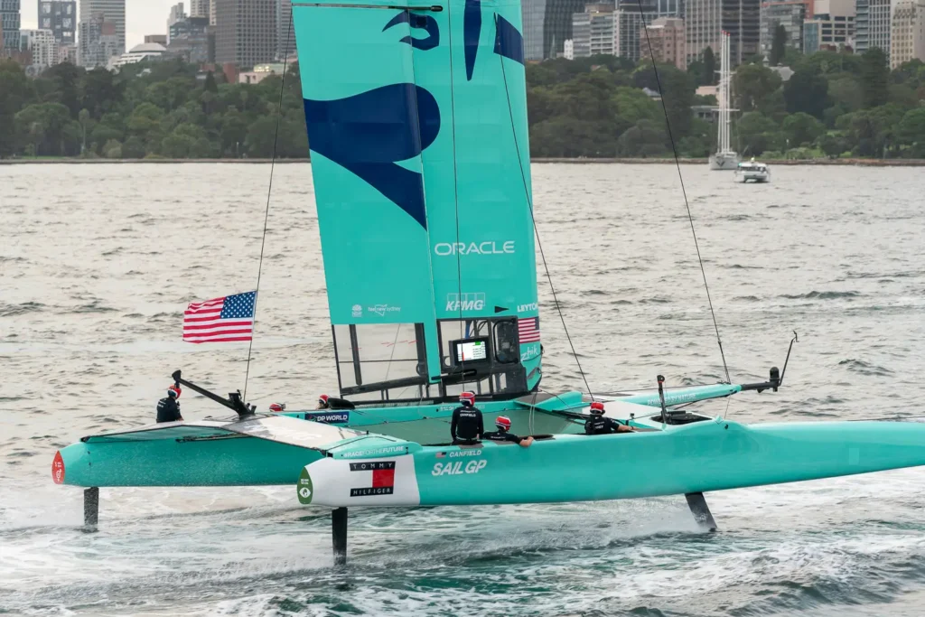 USA SailGP F50 catamaran foiling at speed across Sydney Harbour during SailGP racing