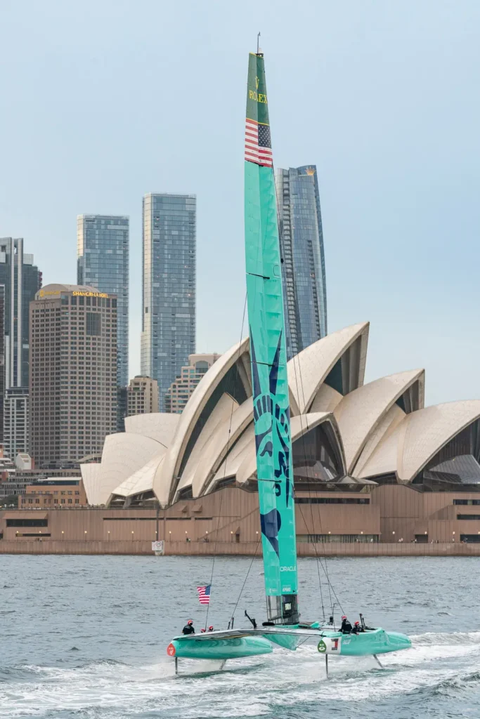 USA SailGP F50 catamaran foiling past the Sydney Opera House during SailGP racing in Sydney Harbour