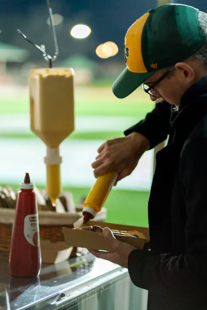 Food vendor preparing a hot dog during the Matildas live site event