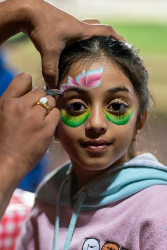 Young supporter with colourful face paint at the Matildas live site in North Sydney