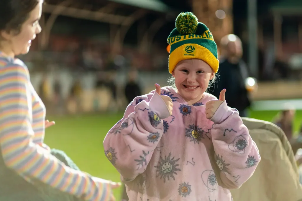 Young Matildas fan giving two thumbs up at North Sydney Oval live site