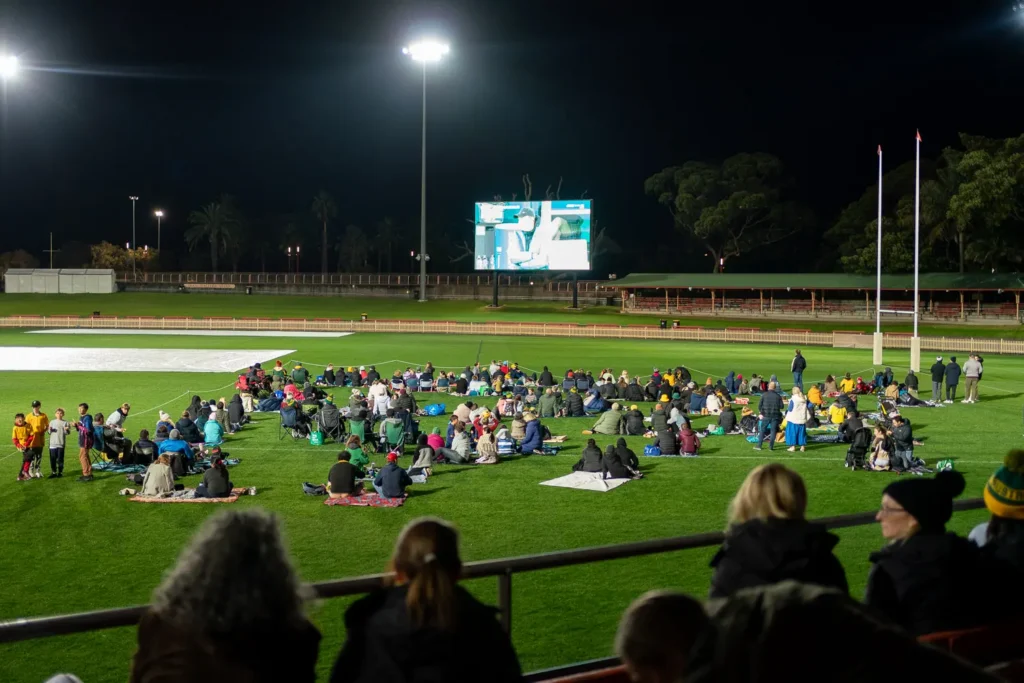 Families gathered on the field watching the Matildas live site at North Sydney Oval