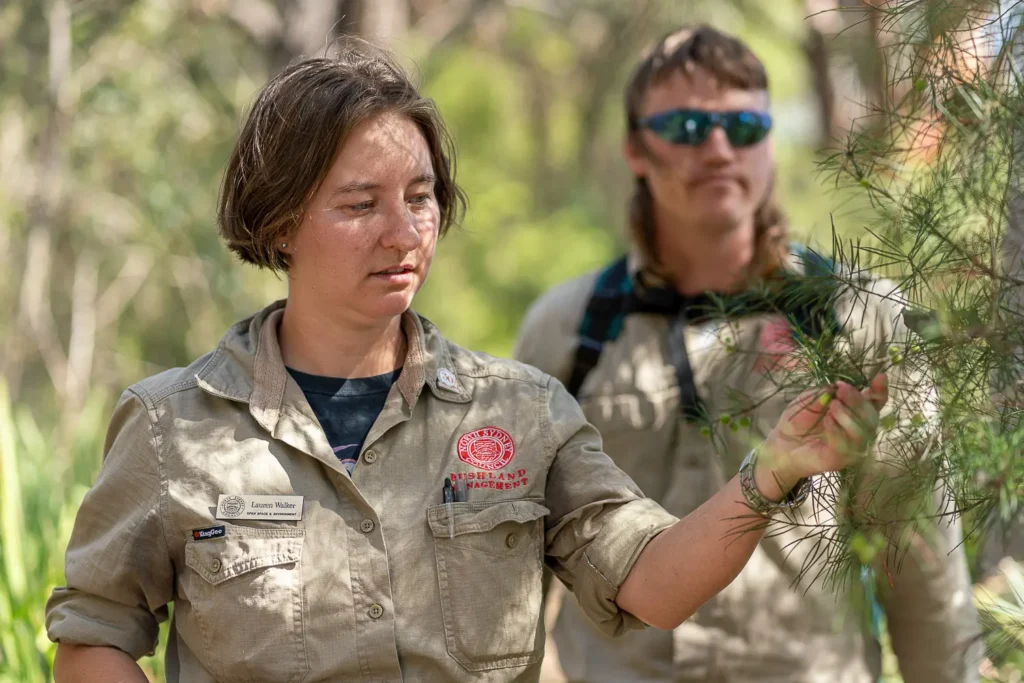 Bushland management educator discussing native plants during an outdoor sustainability event