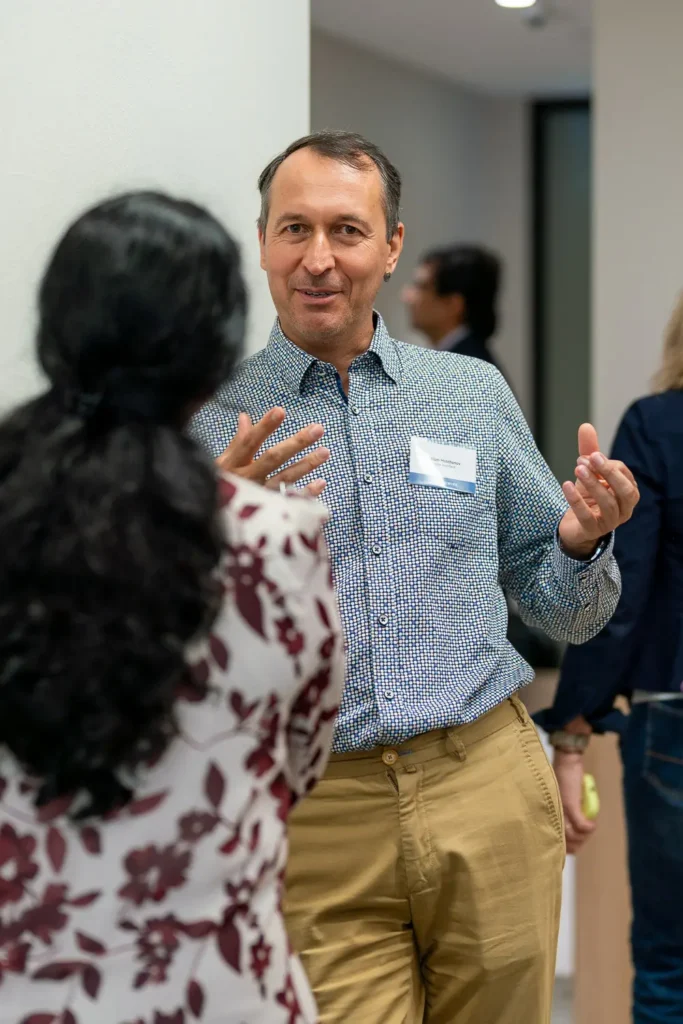 Professionals engaged in conversation during a corporate networking event