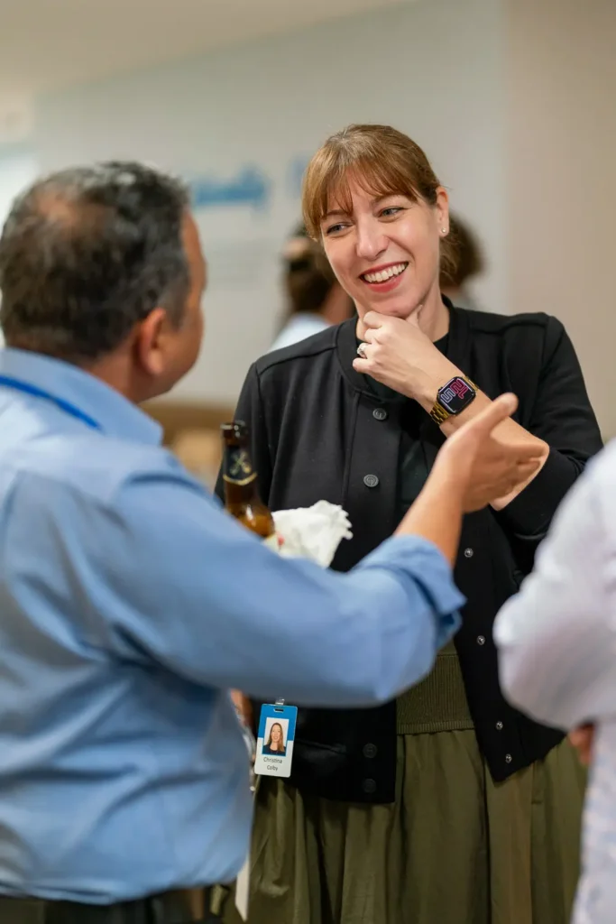 Professionals enjoying a friendly conversation during an office networking event