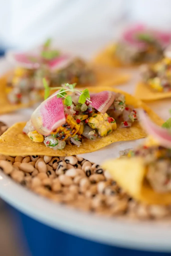 Colourful gourmet canapé topped with radish, corn and fresh herbs