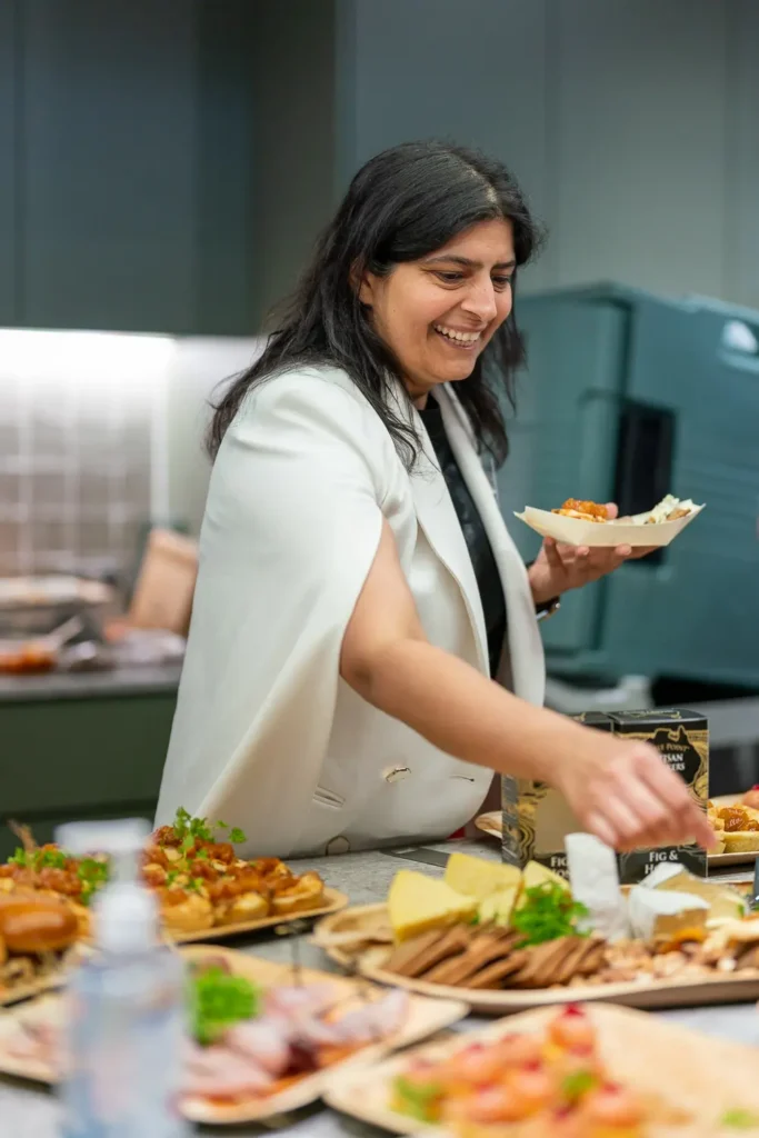 Guest selecting food from a catered spread at a corporate office event