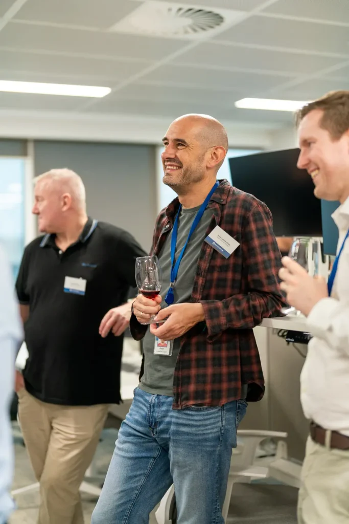 Colleagues enjoying drinks and conversation at a corporate networking function