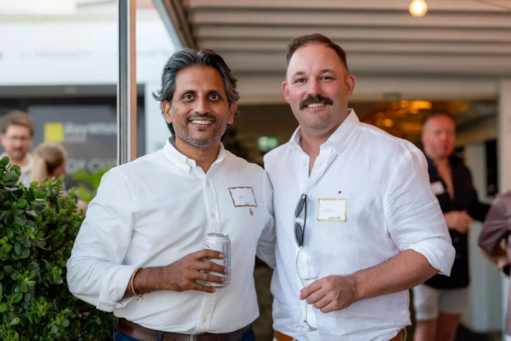Two guests posing together with drinks at the Shift networking event
