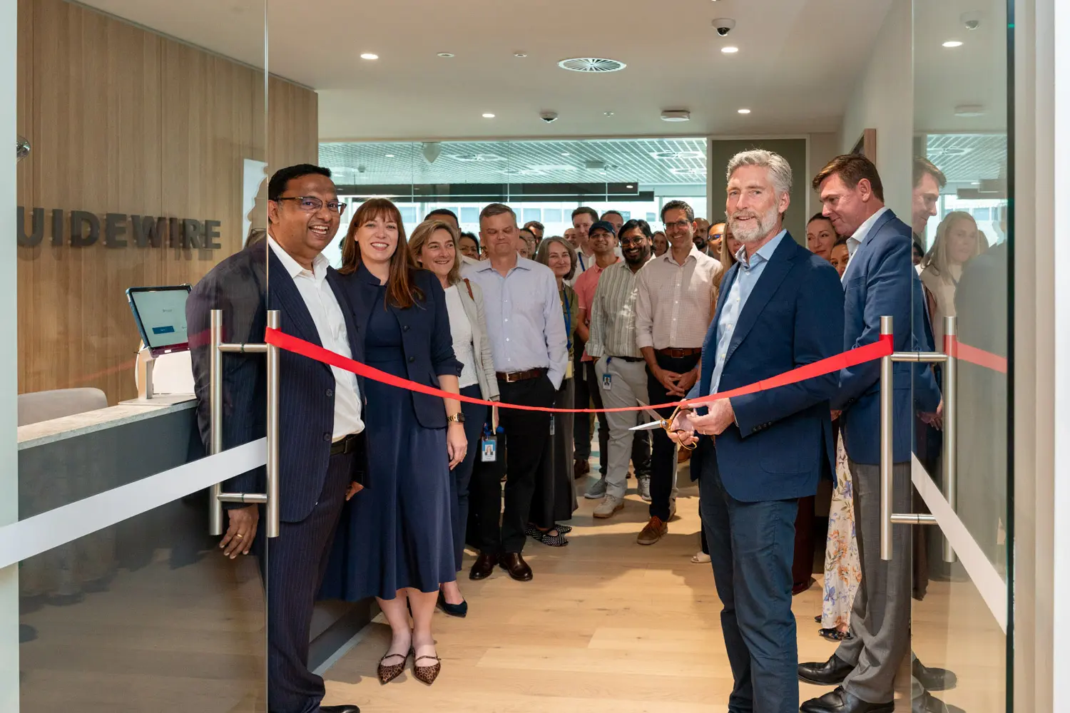Guidewire team celebrating the Sydney office opening with an official ribbon cutting
