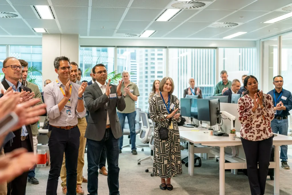Guidewire Sydney team applauding during their new office opening celebration