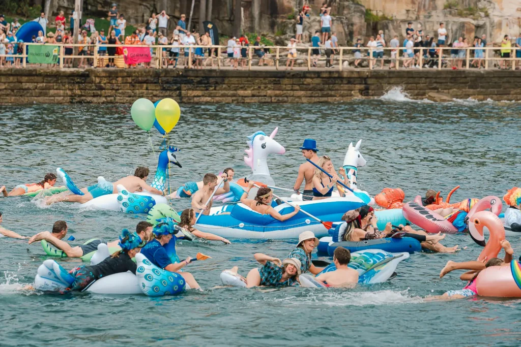 Colourful peacock, unicorn and flamingo inflatables during the Manly boat race