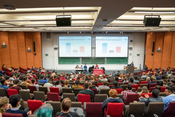 Wide view of a packed lecture theatre during a conference session