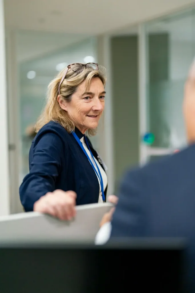 Business professional chatting with a colleague during an office event