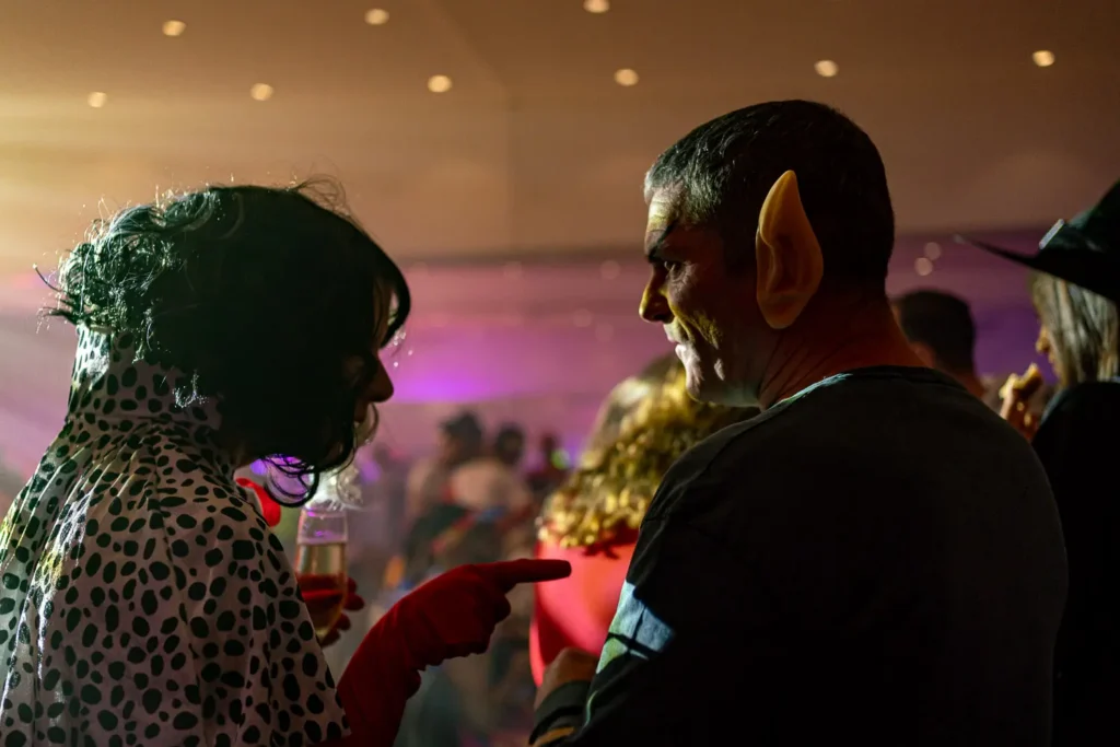 Costumed colleagues chatting during the Quantum Day corporate party