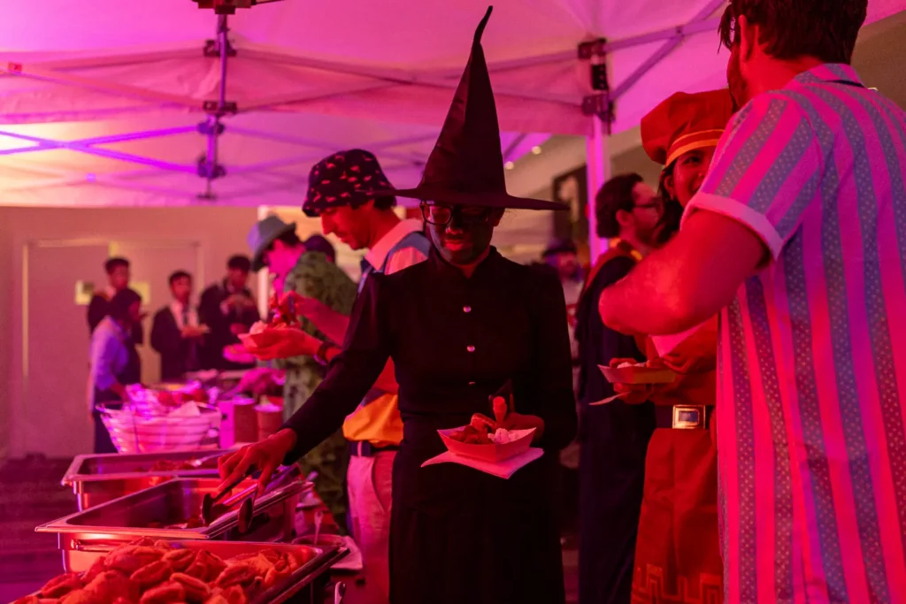 Costumed guests enjoying food at the Quantum Day corporate event