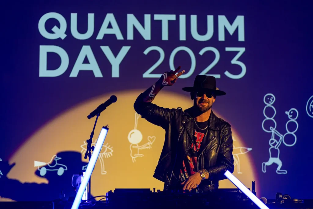 DJ performing on stage at the Quantum Day 2023 corporate event